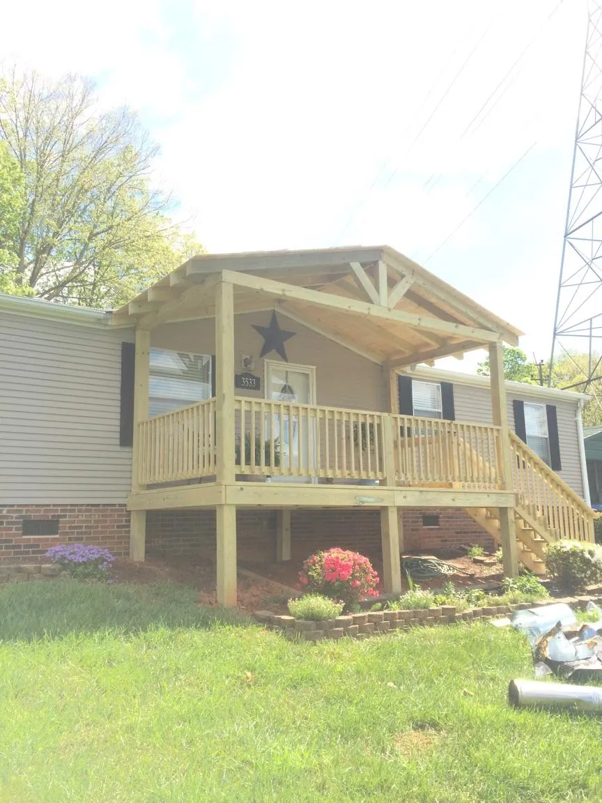 New gabled porch roof and deck railing added to a ranch home in Columbia